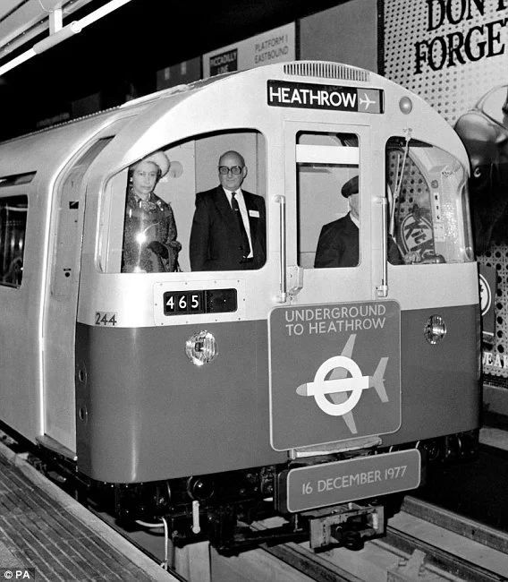 The queen in the drivers cab of the first train to Heathrow Central on 16 December 1977